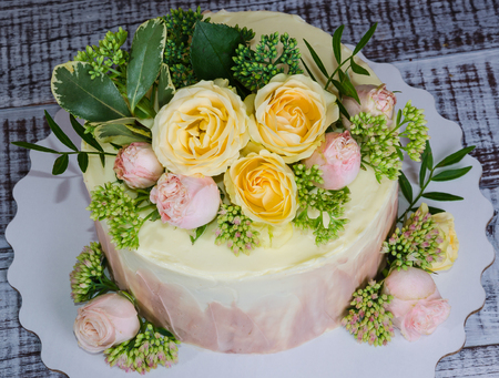 ombre wedding cake decorated with roses and some greeneryの写真素材