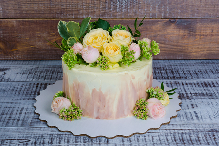 ombre wedding cake decorated with roses and some greeneryの写真素材