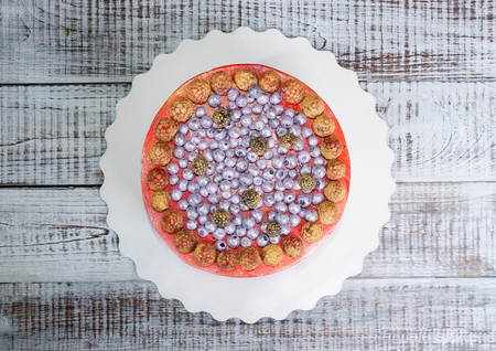 orange cream cheese cake with raspberry, bilberry and  blueberryの写真素材