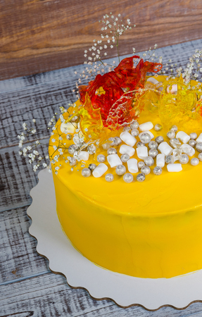 yellow cream cheese cake with caramel decoration and gypsophilaの写真素材