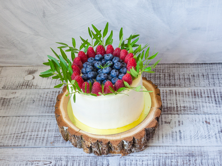 a berry wedding cake and red velvet cupcakesの写真素材
