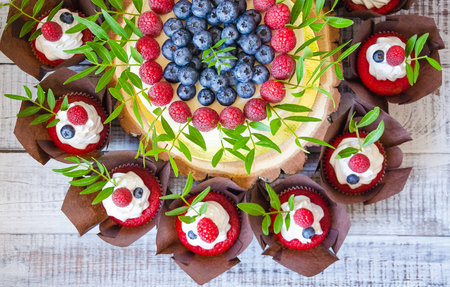 a berry wedding cake and red velvet cupcakesの写真素材