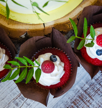 a berry wedding cake and red velvet cupcakesの写真素材