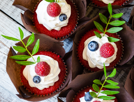 a berry wedding cake and red velvet cupcakesの写真素材