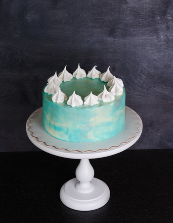 Light blue cream cheese cake with marshmallow and merenguesの写真素材