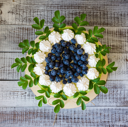 birthday cake wrapped in biscuit tape with blueberries and merenguesの写真素材