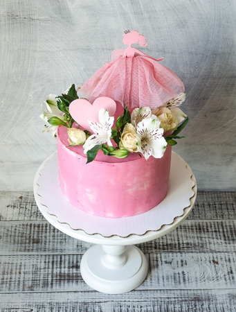pink cream cake for a baby girl with princess topperの写真素材