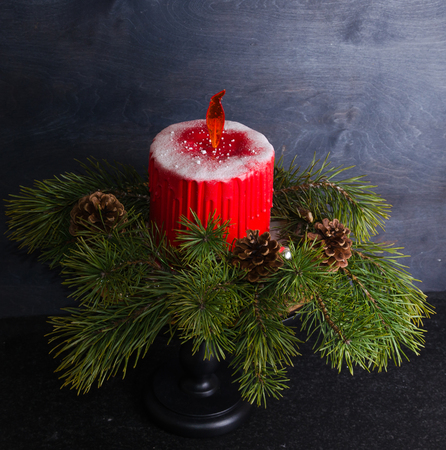 Christmas candle cake with caramel flame decorated with pine treeの写真素材