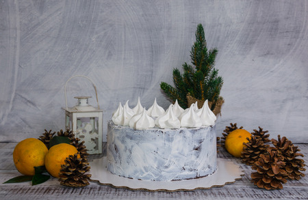 chocolate christmas cake decorated with merengues on wooden backgroundの写真素材