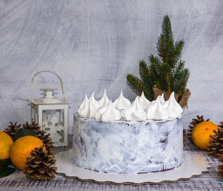 chocolate christmas cake decorated with merengues on wooden backgroundの写真素材
