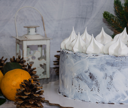 chocolate christmas cake decorated with merengues on wooden backgroundの写真素材