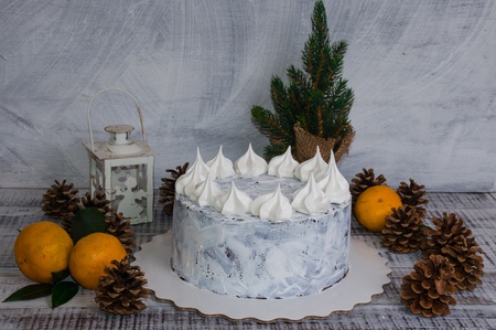 chocolate cristmas cake decorated with merengues on wooden backgroundの写真素材