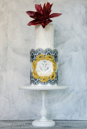 Original wedding two-tiered wedding cake with wafer flowers and birdsの写真素材