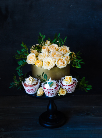 a Gentle wedding cake in golden chocolate box with yellow roses and pistachioの写真素材