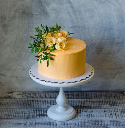 orange cream cheese cake with roses and pistachioの写真素材
