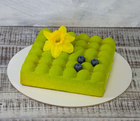 Square Chocolate velvet cake with daffodil and blueberriesの写真素材