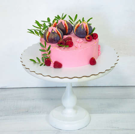 Figs cream cheese cake with pistachio leaves and gilded raspberryの写真素材