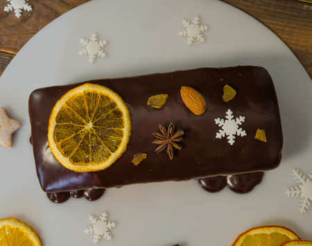 Chocolate orange Christmas cake with fir tree and other decorationの写真素材