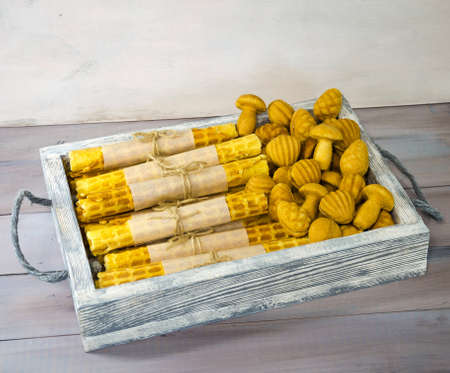 Retro sweets with caramel on wood with old fashioned candle standの写真素材