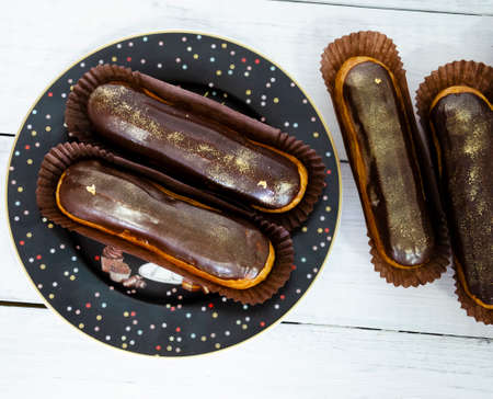 Gorgeous extra chocolate eclairs with gilded glazeの写真素材