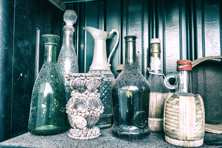 Old dirty bottles on tableの写真素材