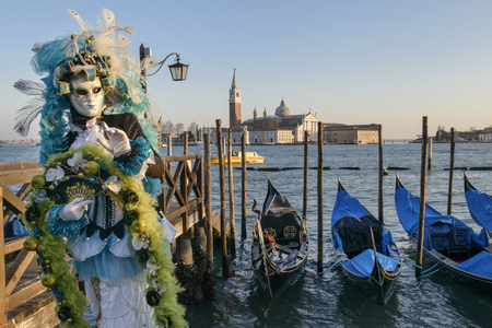 Masked woman with a backdrop of Veniceの写真素材