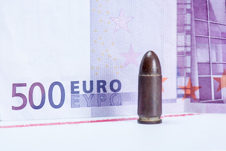 bullet for gun with euro money and strip of bloodの写真素材