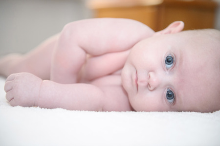 Baby girl posing with bright eyes, baby is newborn and very littleの写真素材