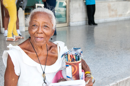 Old woman whit blue eyes selling candy in the streetの写真素材