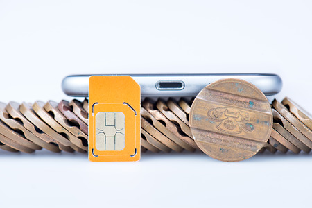 new generation phone with old telephone tokens, and SIM in still lifeの写真素材