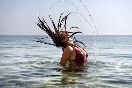 Woman at sea in the waterの写真素材