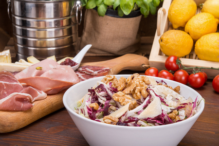 Salad with fennel, parmesan slices and walnuts on italian tableの写真素材