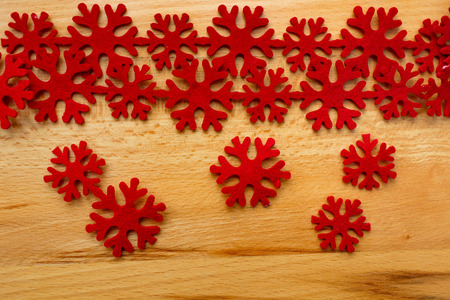 Garland of Christmas red snowflakes on a wooden backgroundの写真素材