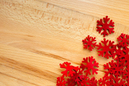 Horizontal wood background, red snowflakes on the right. Left space for your text or design.の写真素材