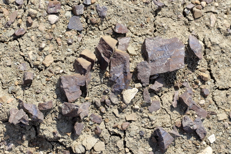 Brown clumps of dried clay on dry ground, close-up, top view.の写真素材