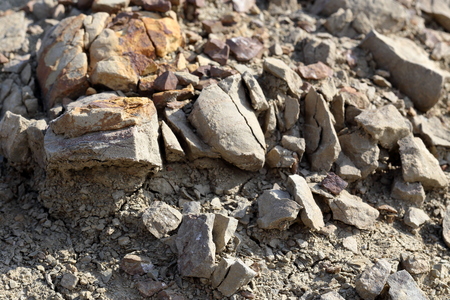 Brown clumps of dried clay on dry ground, close-up. Selective focus in the foreground.の写真素材