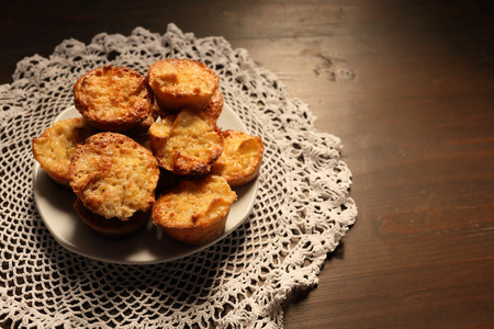 Beautiful muffins on a dark wooden background. Vignetting and darkening on the background, light on sweets.の写真素材