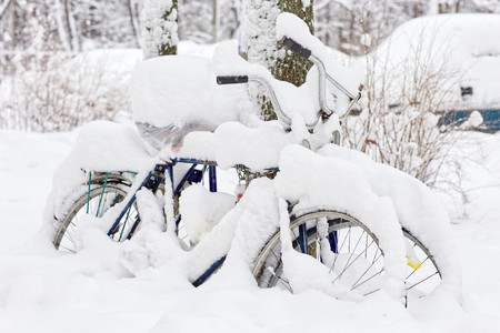 Bicycle covered with snow. Very heavy snowfall. Bicycle in the winter.の写真素材