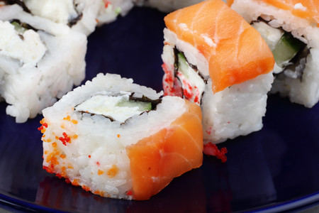 Sushi is very close-up on a dark blue background.の写真素材