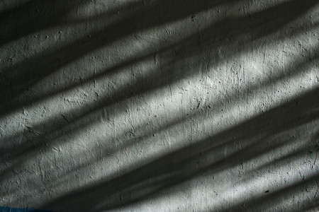 Wall with beautiful shadows. Dramatic background. Abstract background.の写真素材