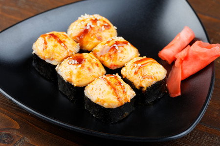 Set sushi on a black triangular plate with ginger closeup. Appetizing Japanese food.の写真素材