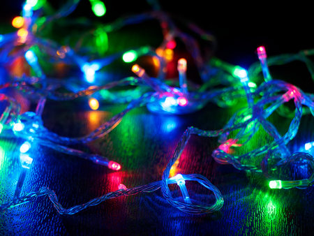 Christmas garland on a dark background. Glowing Christmas garland. New Year and Christmas...
