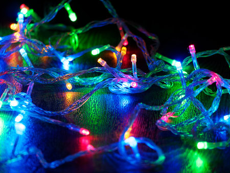 Christmas garland on a dark background. Glowing Christmas garland. New Year and Christmas decorations and backgrounds. nds. Selective focus.の写真素材