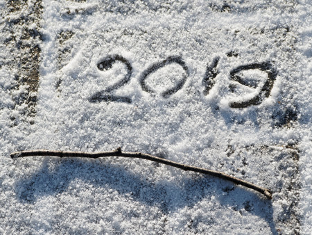 Inscription 2019 on the snow. The inscription and twig on the snow. Christmas background.の写真素材