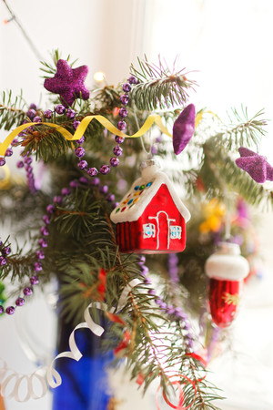 Blurred christmas background. The branch of the Christmas tree decorated with Christmas toys. Selective focus, blur bokeh.の写真素材