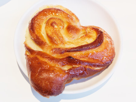 Bun Moscow. Bun with sugar in the shape of a heart. Traditional Russian cinnamon pastries.