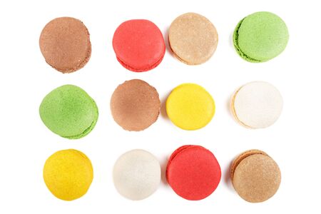 Macarons on a white background. Many colored macaroons top view.の写真素材