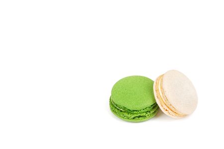 Sweet fresh macaroons. Two macaroons lying on top of each other on a white background, green and white.の写真素材