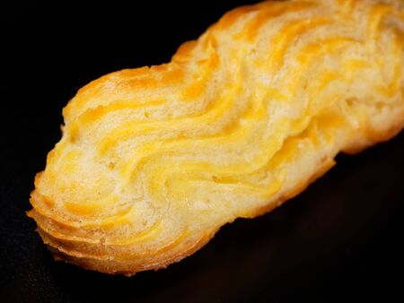 Fragment of eclair closeup. Sweet homemade cakes.の写真素材