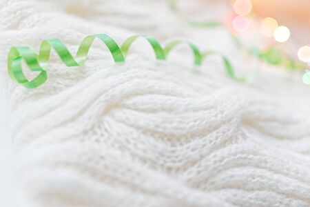 White knitted with a pattern textured background. Selective focus, blurred background.の写真素材